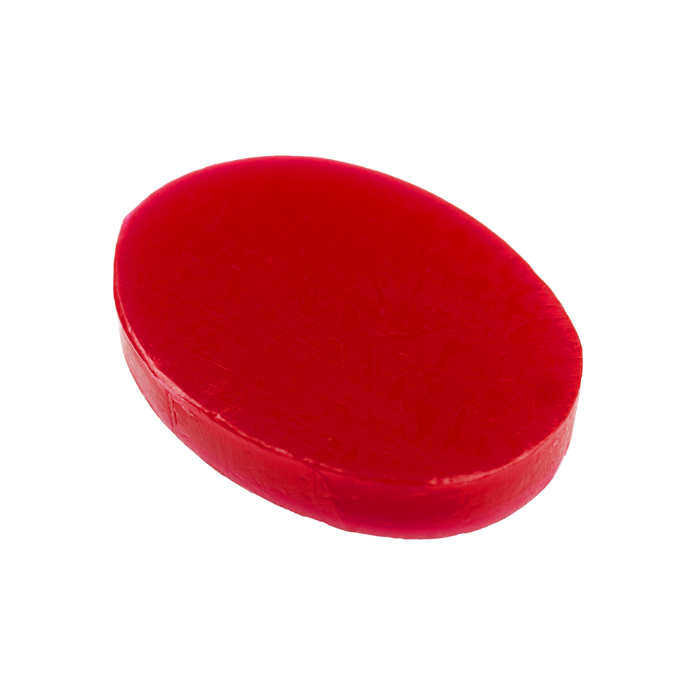 Das Bild zeigt ein rotes, ovales Stück Fingerwachs. Es wird häufig im Theater oder zu Halloween für Schmink- und Spezialeffekte verwendet.